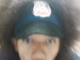 Curly police officer with blue eyes sucks a big dildo for her colleagues.